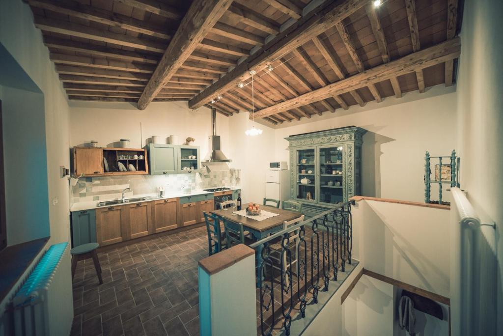 a large kitchen with wooden cabinets and a balcony at CASA AL MIGLIO in Pratolino