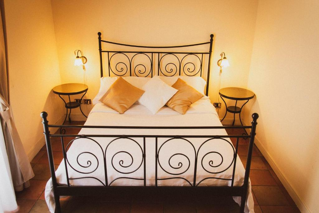 a bedroom with a bed with pillows on it at Antica Dimora Caruso in Catania