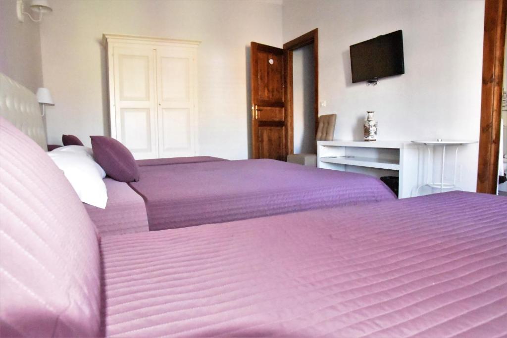 Postel nebo postele na pokoji v ubytování Simonetta's Rooms