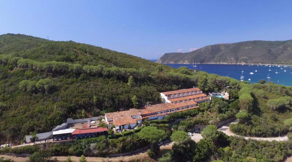 a train station on a hill next to the water at Hotel Capo Di Stella in Capoliveri