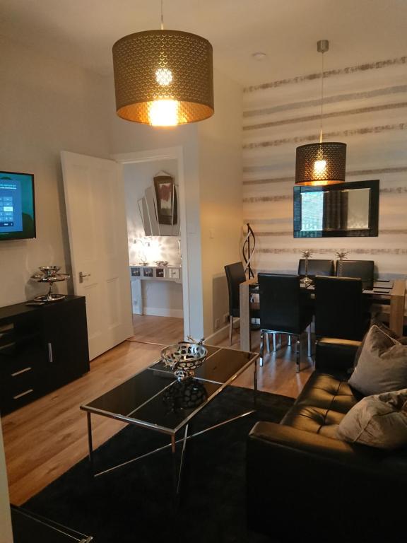 a living room with a couch and a table at William Wallace Apartment in Stirling