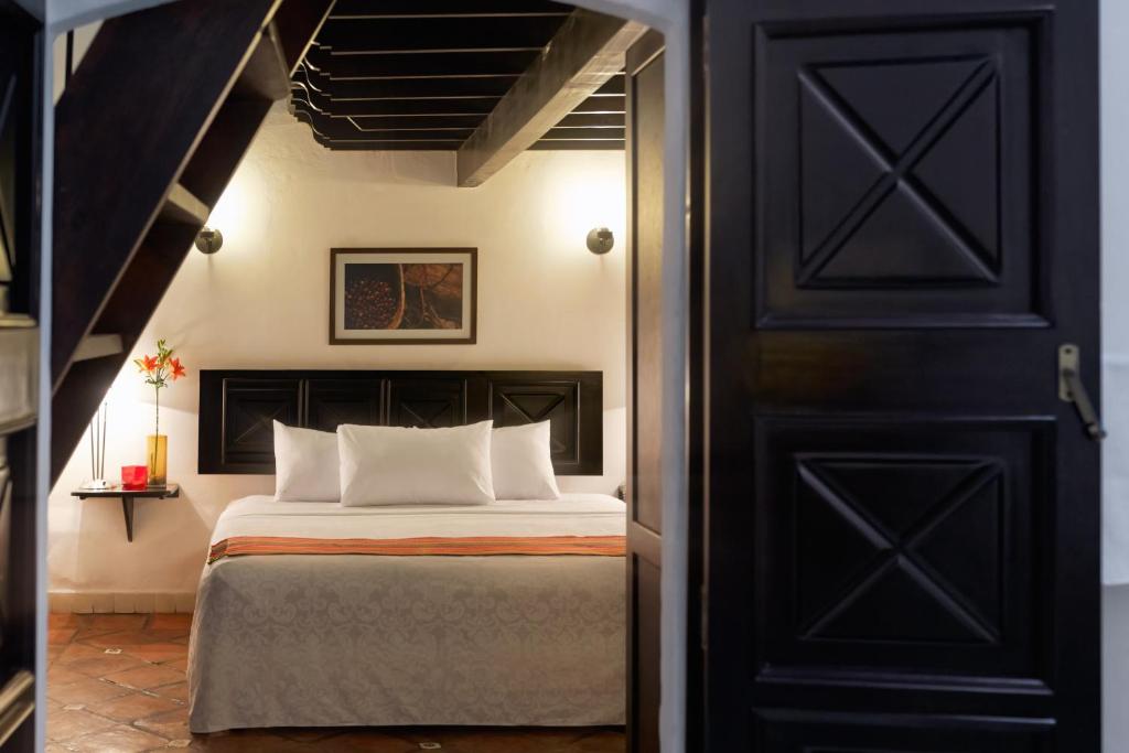 Postel nebo postele na pokoji v ubytování Hotel Casa Real Del Café