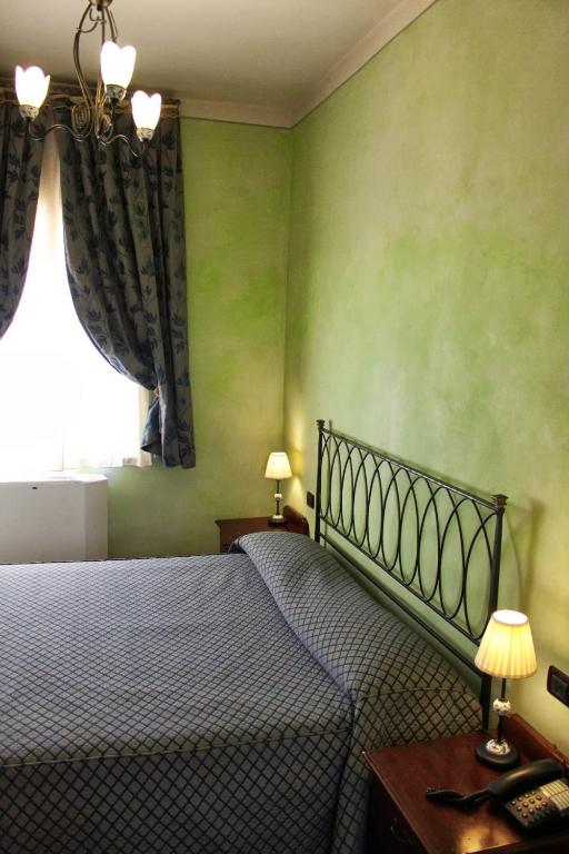 Postel nebo postele na pokoji v ubytování Castello Montegiove