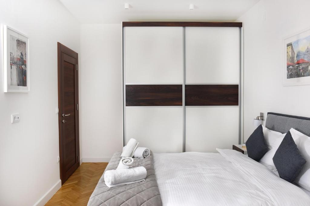 a bedroom with a bed with two towels on it at Apartments Belvedere in Belgrade