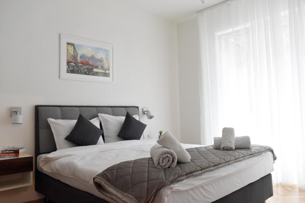 a bedroom with a large bed with towels on it at Apartments Belvedere in Belgrade