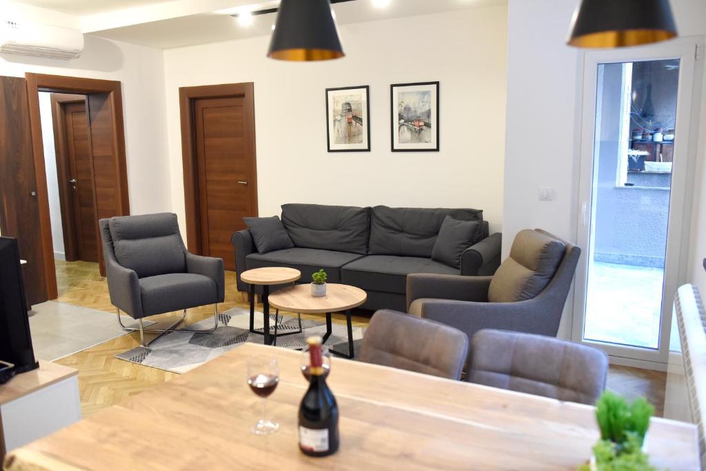 a living room with a couch and chairs and a table at Apartments Belvedere in Belgrade