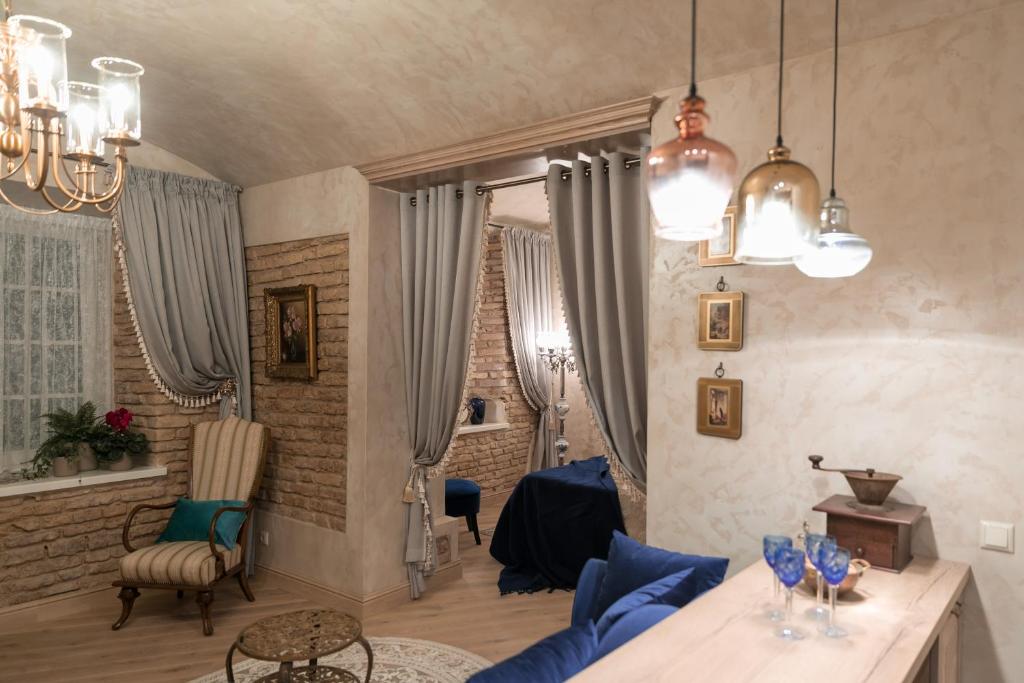 a living room with a blue couch and a table at Luxury apartment in Pilies street in Vilnius