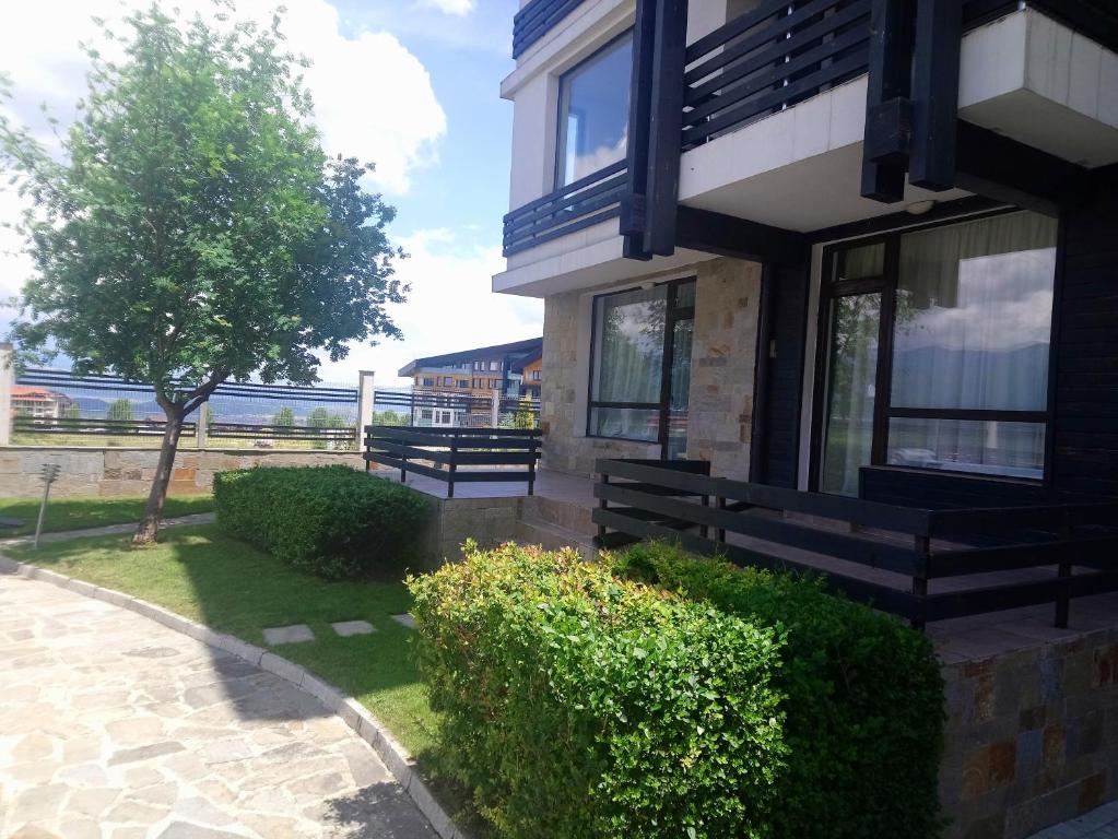 a building with benches on the side of it at Studio L006 in Aspen Golf in Bansko
