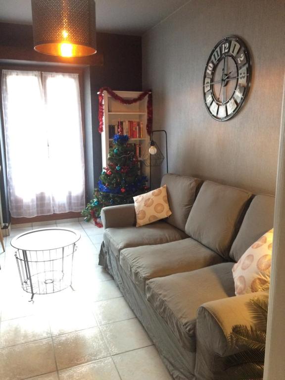 a living room with a couch and a christmas tree at Appartement Orion in Colmar