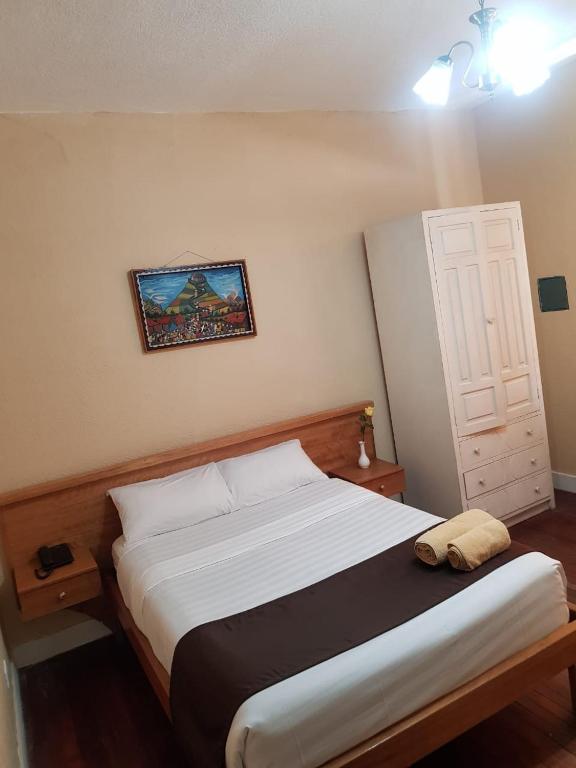 Postel nebo postele na pokoji v ubytování Hostal Loro Verde