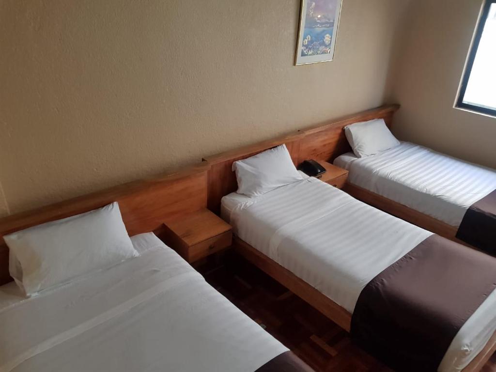 Postel nebo postele na pokoji v ubytování Hostal Loro Verde