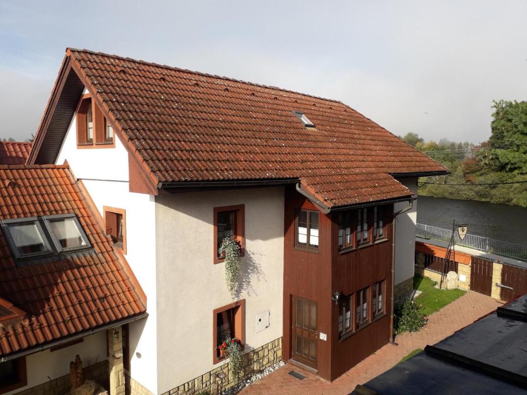 an aerial view of a house with a red roof at River Side Holiday Home near Besenova in Ivachnová