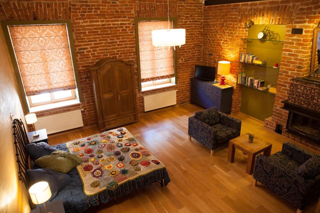 a living room with a couch and a table at Luxury Kaunas Old Town Apartment in Kaunas