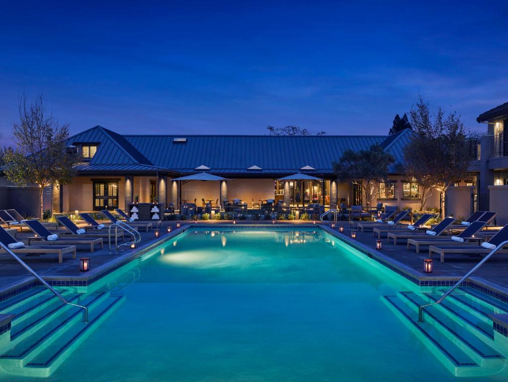 a swimming pool filled with lots of blue umbrellas at Villagio at The Estate Yountville in Yountville