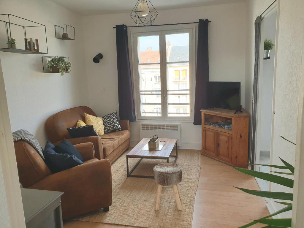 a living room with a couch and a table at Plage port tout à pied in Dieppe
