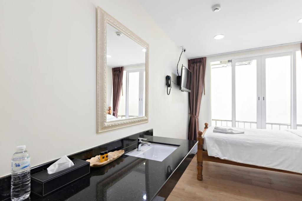 Postel nebo postele na pokoji v ubytování Royale 8 Ville Guest House