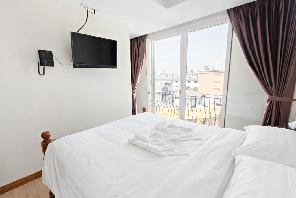 Postel nebo postele na pokoji v ubytování Royale 8 Ville Guest House