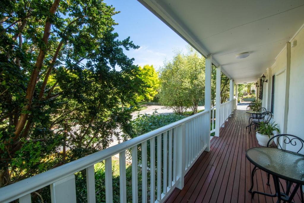 a balcony with a table and chairs on a house at Yarra Gables in Healesville