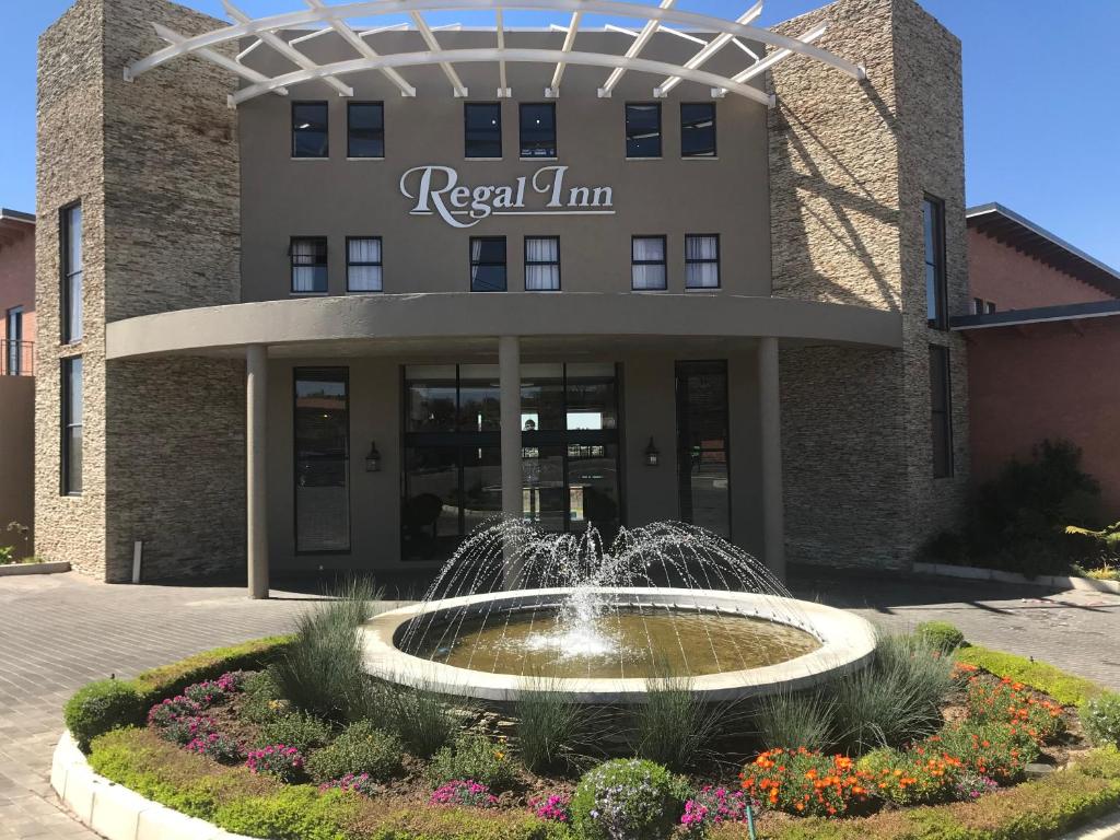 a building with a fountain in front of a building at Regal Inn Hotel Midrand in Midrand