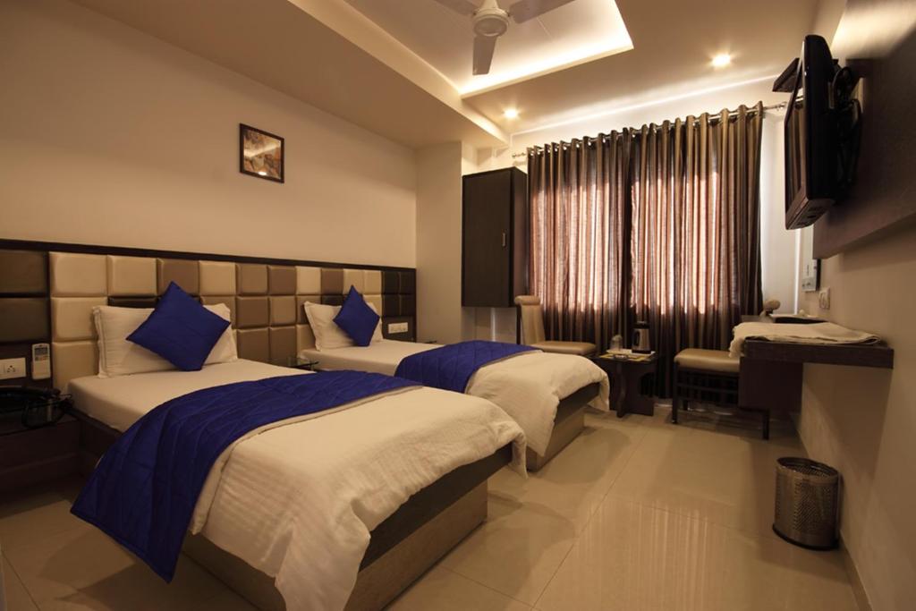 Postel nebo postele na pokoji v ubytování Hotel Flair Inn