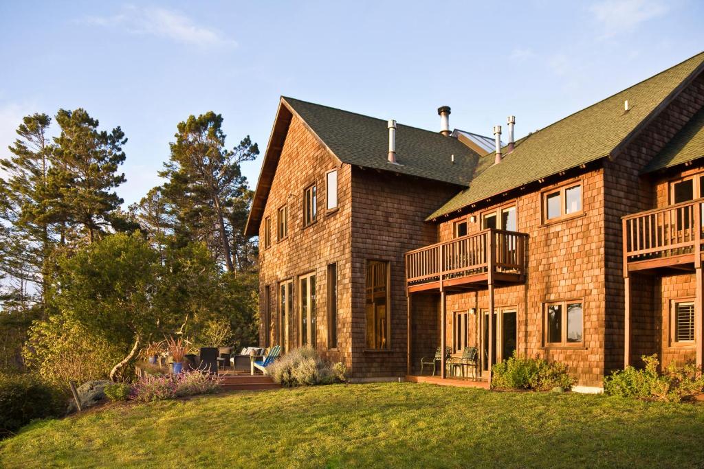 a large brick house with a yard at Brewery Gulch Inn in Mendocino