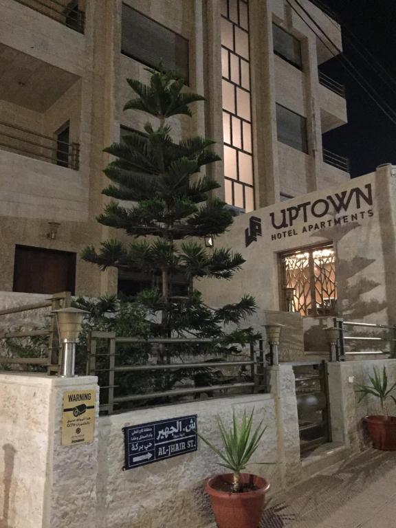 a christmas tree in front of a building at Uptown Hotel Apartment in Amman