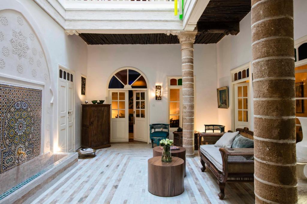 a living room with a couch and a table at Riad Emotion in Essaouira