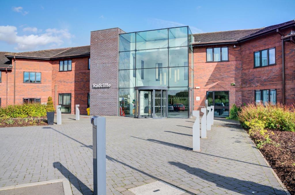 a large brick building with a glass facade at Warwick Conferences - Radcliffe in Coventry