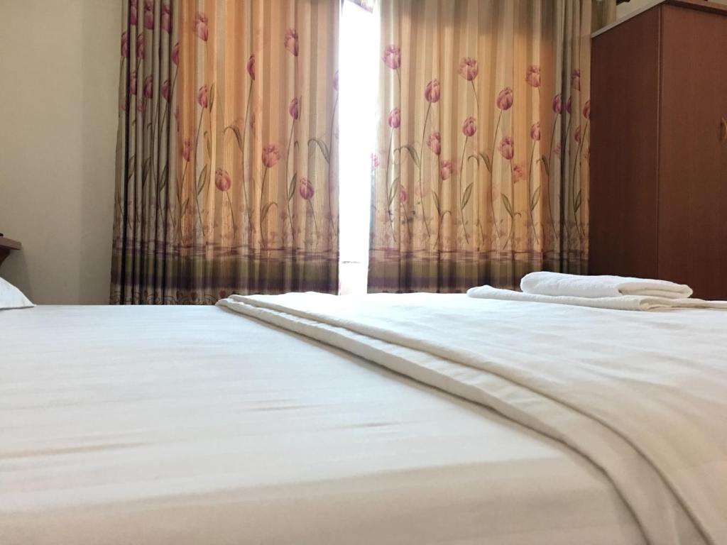 Postel nebo postele na pokoji v ubytování Van Anh Hotel