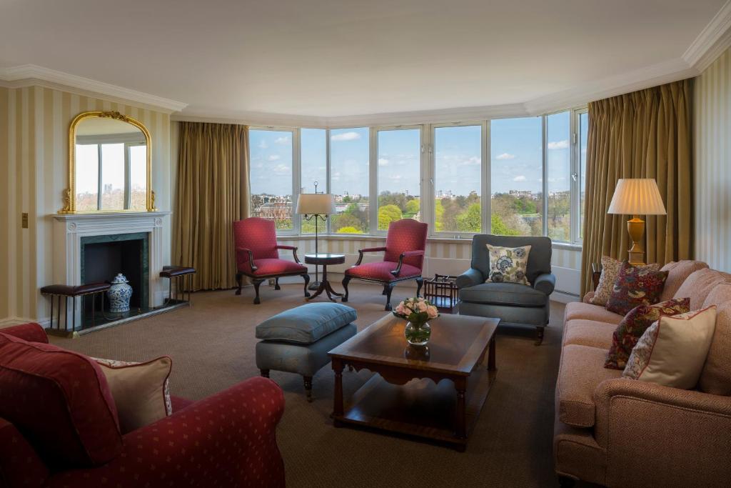 a living room with couches and chairs and a fireplace at Cheval Thorney Court at Hyde Park in London