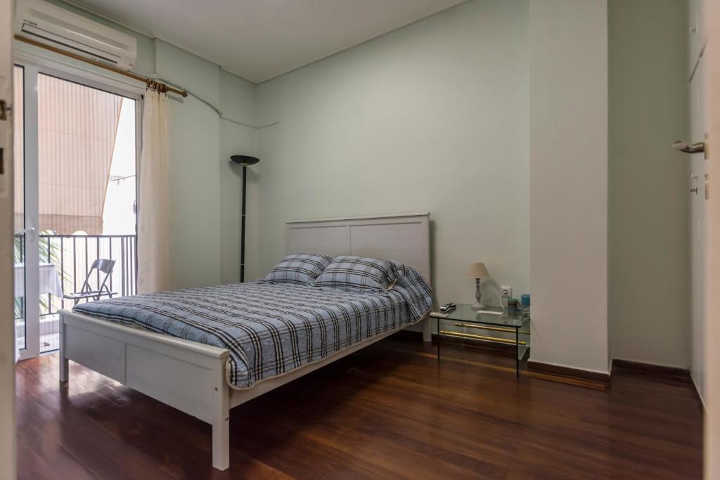 una camera con letto, tavolo e finestra di Cozy & Quiet Central Apartment a Kalamáta