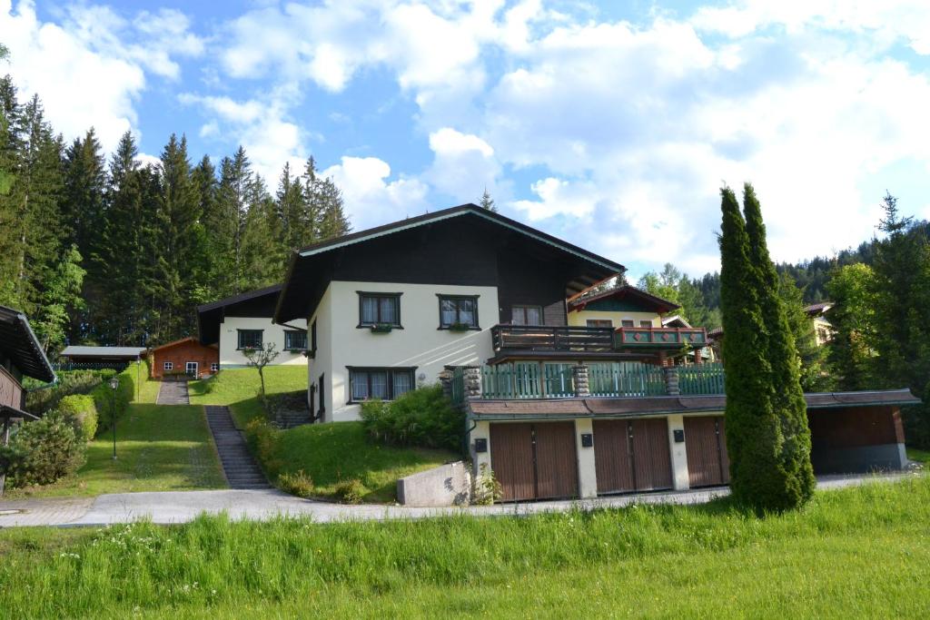 a house with a balcony on top of it at Ferienwohnungen Walcher in Ramsau am Dachstein