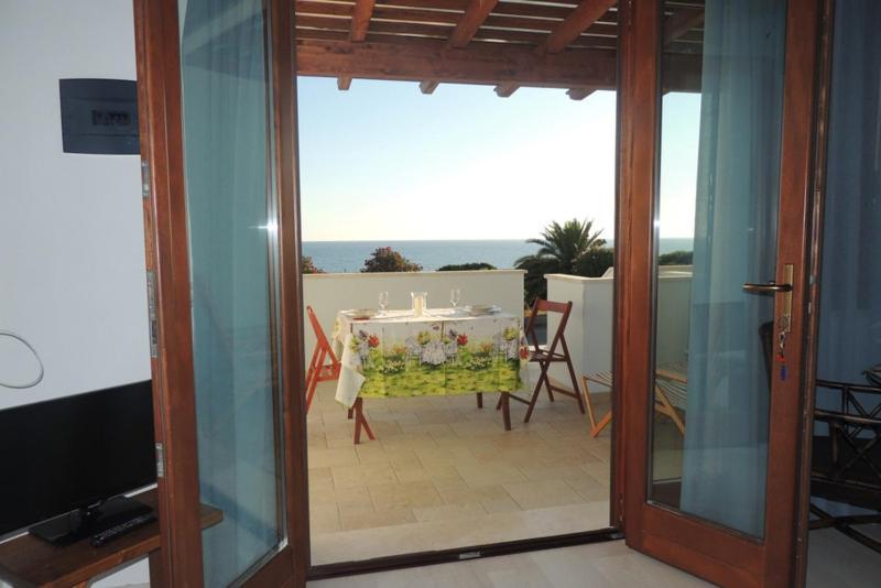 a dining room with a table and a view of the ocean at SENAFER Funtana Meiga in Funtana Meiga