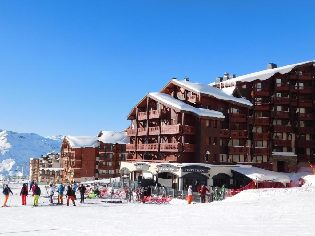 a group of people standing in the snow in front of a building at Village Montana in Val Thorens