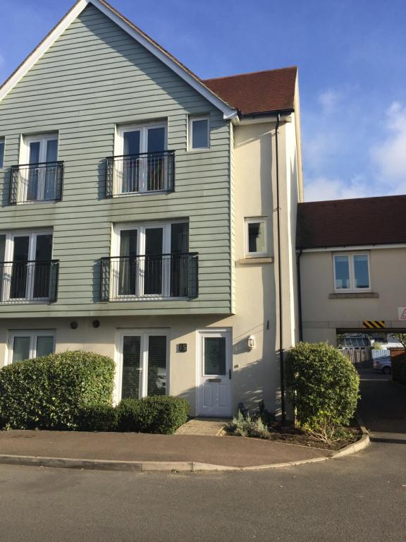 a large house with a balcony on a street at Watercolour House in Redhill