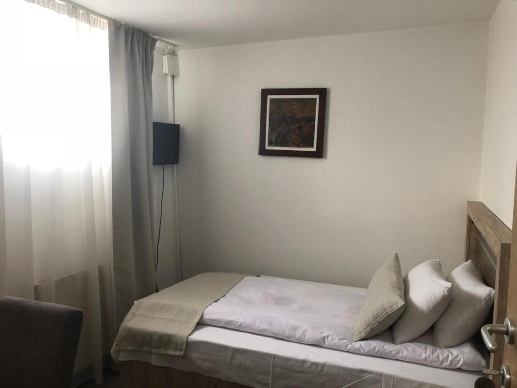 A bed or beds in a room at Gros Hotel - Leskovac
