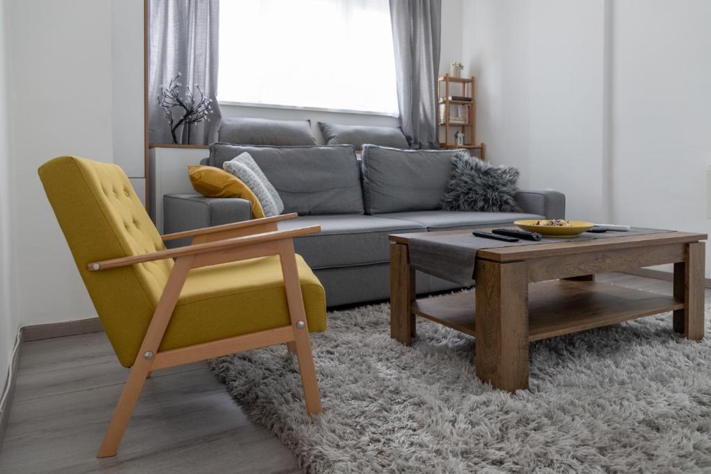 a living room with a couch and a table and chairs at Jumi in Belgrade