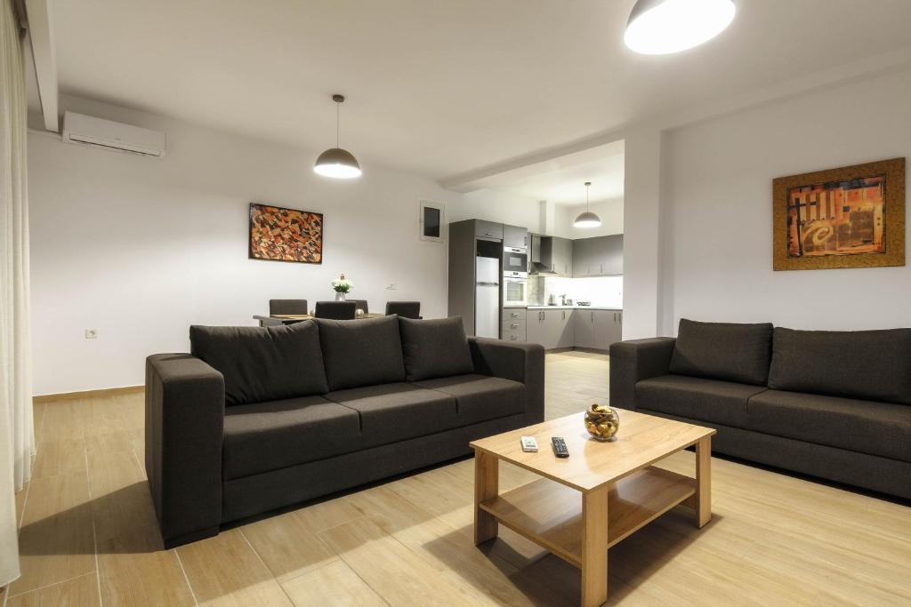 a living room with two couches and a coffee table at Oresteia Downtown Apartment in Zakynthos Town