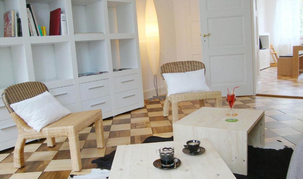 a living room with two chairs and a coffee table at B&B Laupenring, Basel in Basel