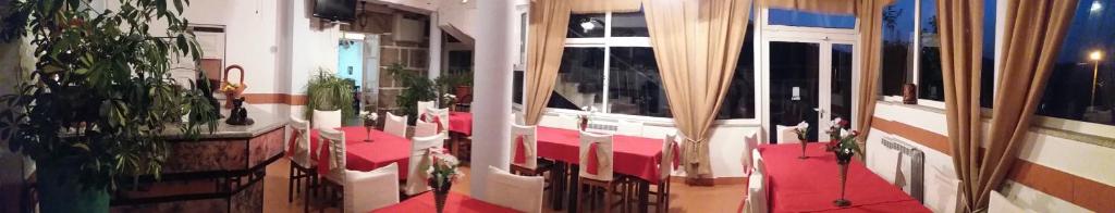 a room with a red floor with plants on it at Hotel gite cantinho davo in Vila Real