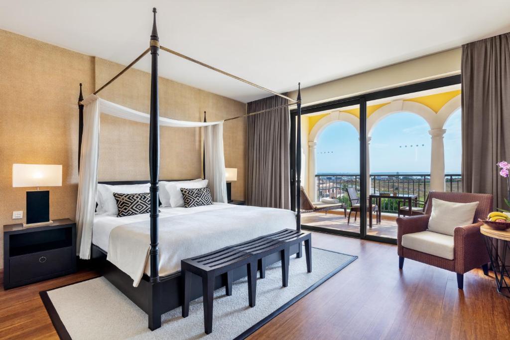a bedroom with a canopy bed and a balcony at Cascade Wellness Resort in Lagos