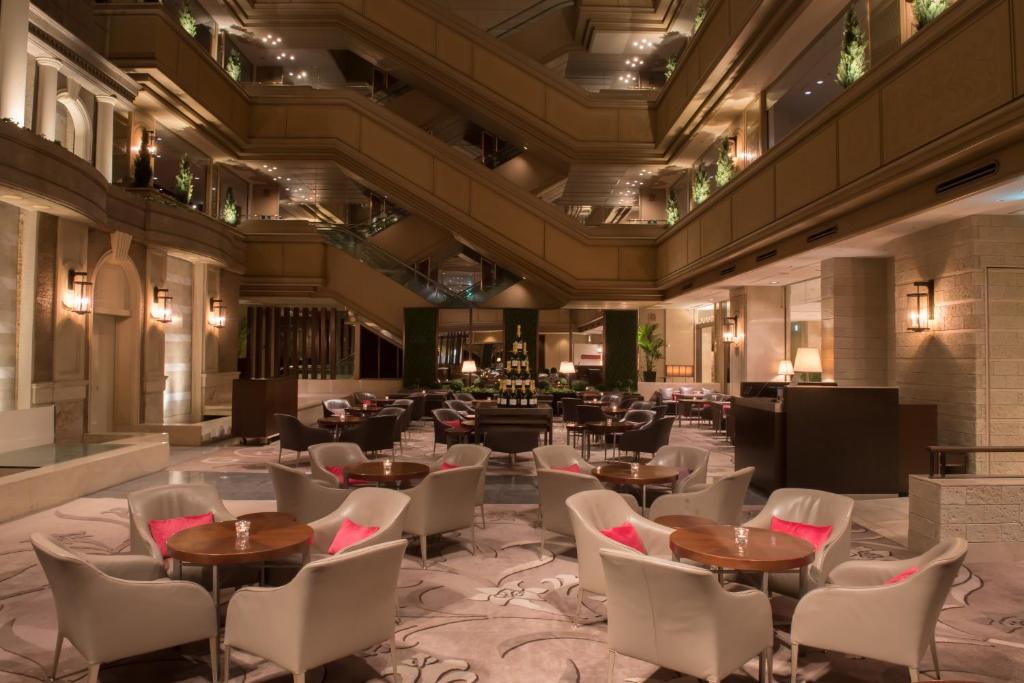 a restaurant with tables and chairs in a building at Nagoya Tokyu Hotel in Nagoya