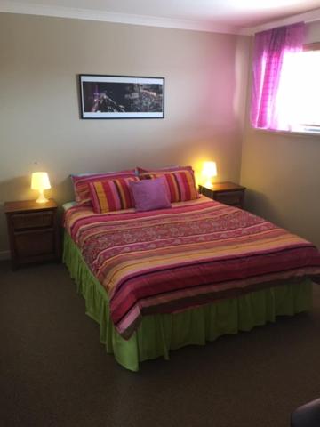 a bedroom with a large bed with two lamps at Beautiful Retreat by the Beach - 1 Lecaille Court in Dunsborough
