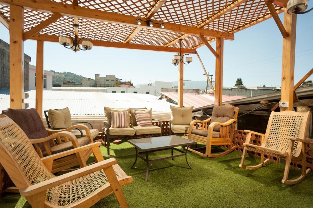 a group of chairs and tables on a roof at Hotel Vintage "Casa las Flores" in Quetzaltenango