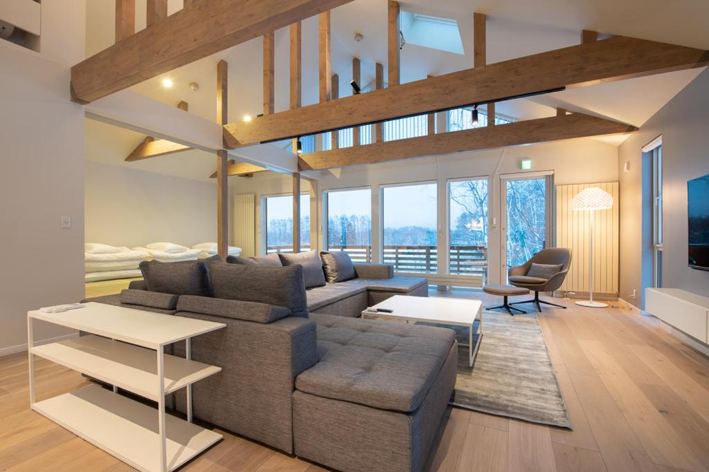 a living room with a couch and a table at Yotei Yama House in Niseko