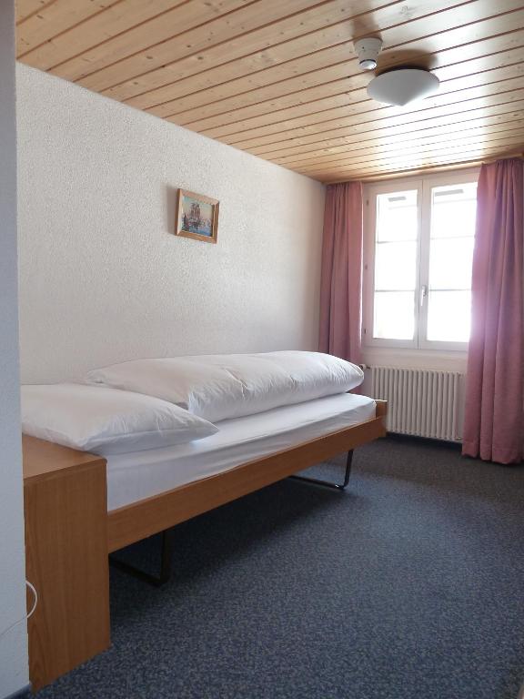 Postel nebo postele na pokoji v ubytování Berghaus Männlichen