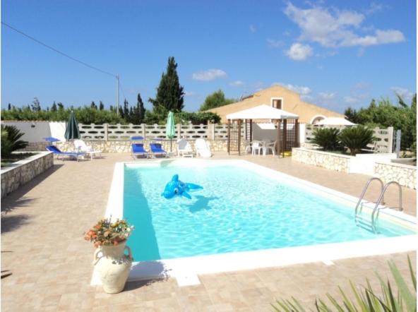 a swimming pool with a person in the water at Residenza agrituristica Santa Lucia con piscina in Alghero