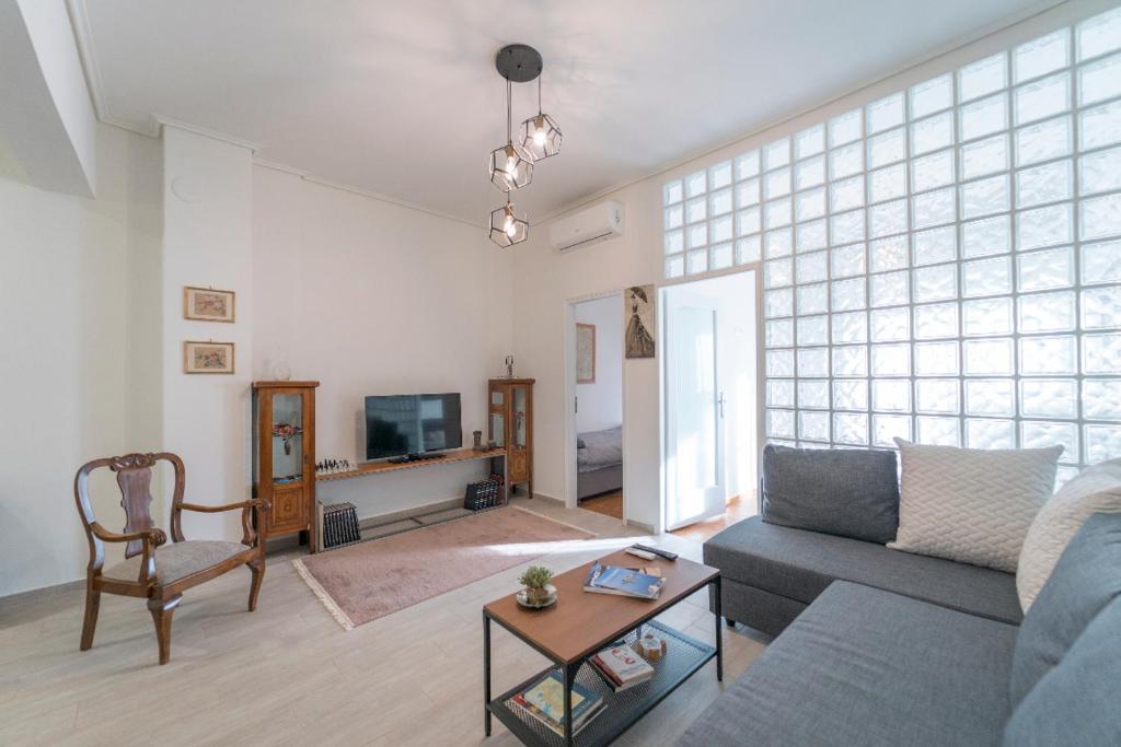 a living room with a couch and a table at Piraeus_Faliro_Cosy apartment in Piraeus