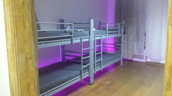 a room with two bunk beds with purple lights at Art Studio in Braşov