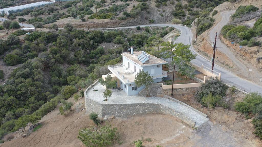 an overhead view of a house on a hill with a road at Skouros Villa in Kastrí